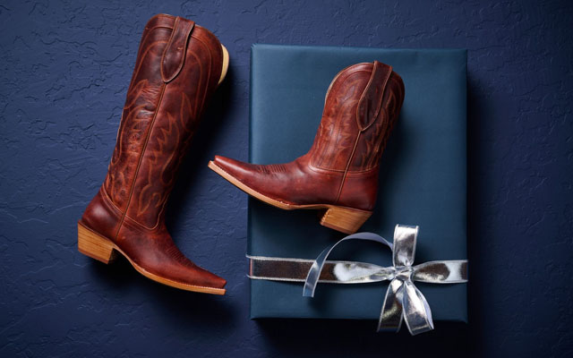 One Jess 15” Women's Western in Cognac and one Areli Women’s Western in Cognac laying on a gift box.